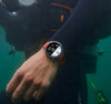 Person underwater wearing a smartwatch with diving computer display